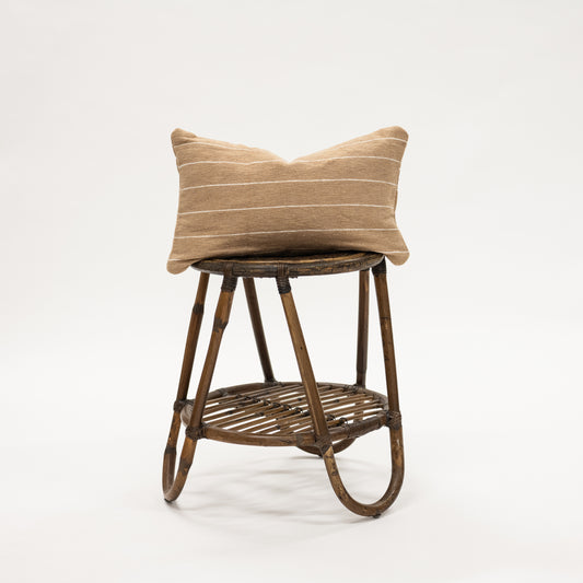 Beige Striped Woven Lumbar Pillow 12x20" on a wicker stool