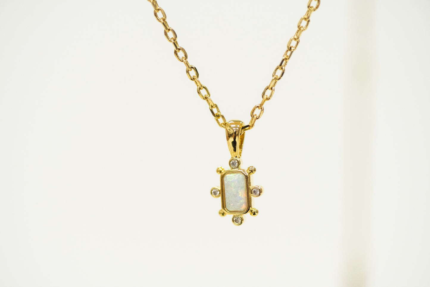 Opal Bar Shaped Pendant with Mini CZ studs on a gold Necklace