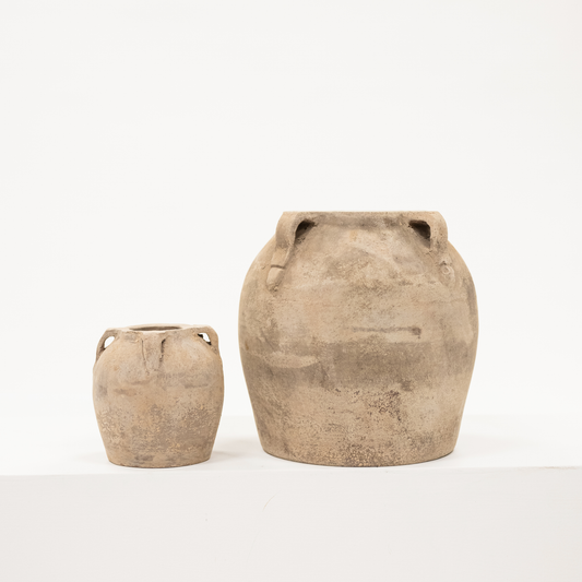 small and large sized four handled vase with a chalky finish and beige color