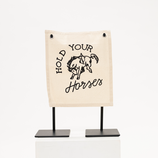 canvas wall sign with phrase hold your horses and hand drawn horse