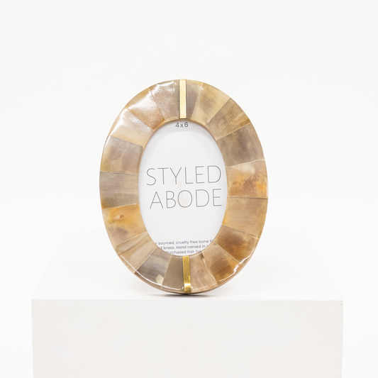oval shaped 4x6 frame with horn tile and brass inlay