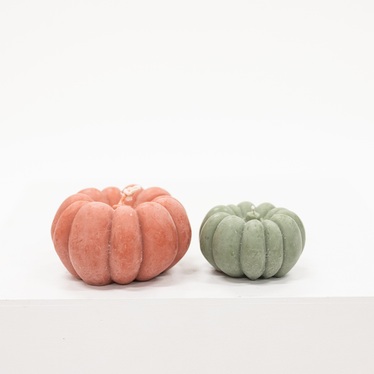 pair of pumpkin shaped candles in terracotta orange and light olive green