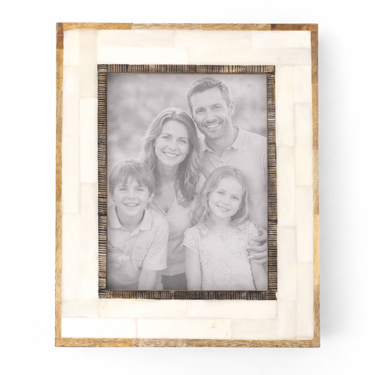 Wooden picture frame with a family photo inside on a white background