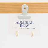 Gold hoop earrings on a white card with 'Admiral Row' branding.