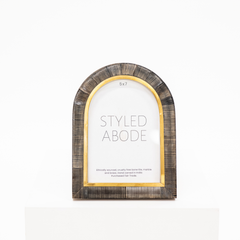 5x7 arch picture frame with carved ridges in a dark horn