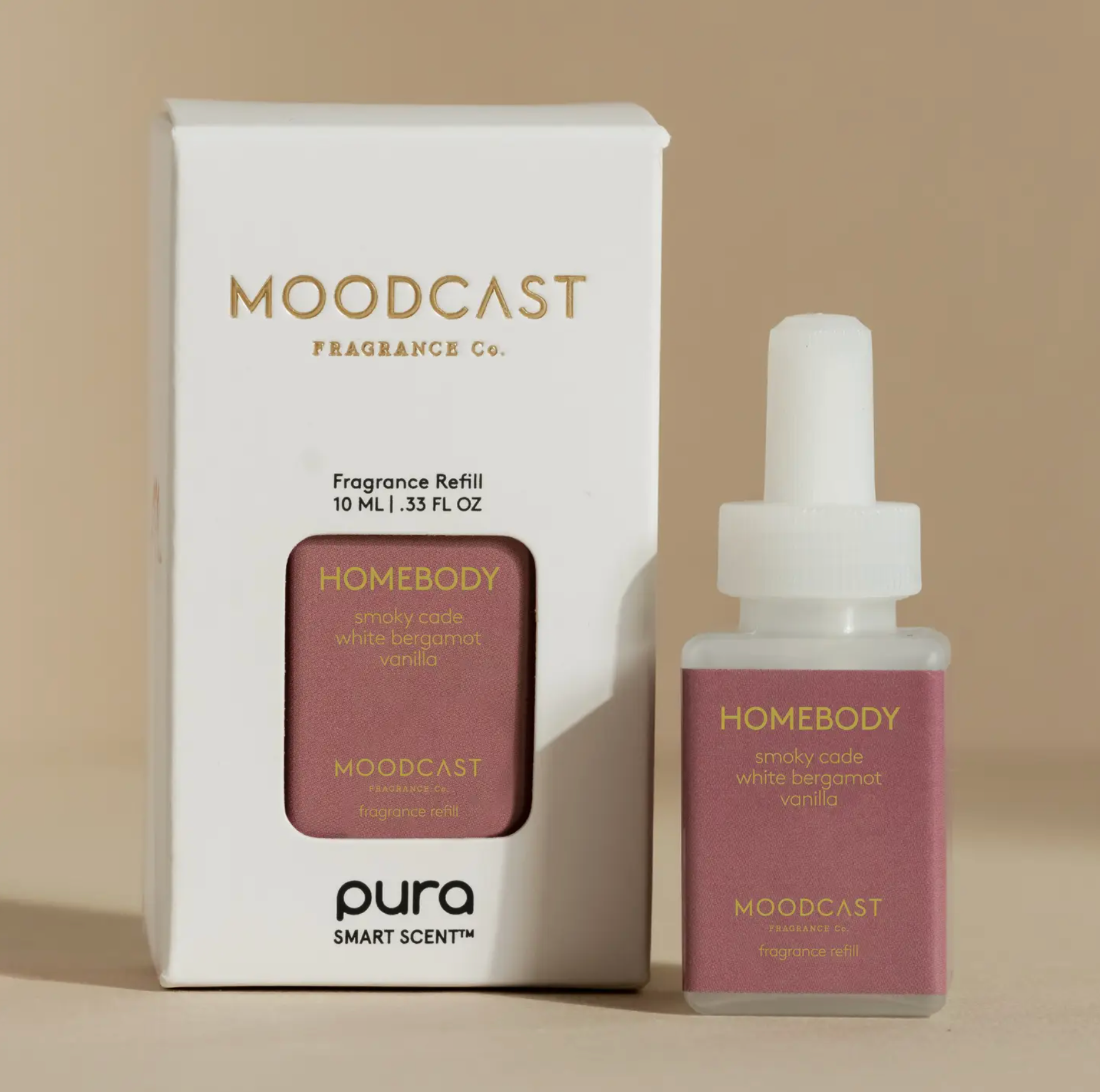 Moodcast Fragrance Co. Homebody fragrance refill set, featuring a white box and a white dropper bottle with a dusty rose label, on a warm beige background.