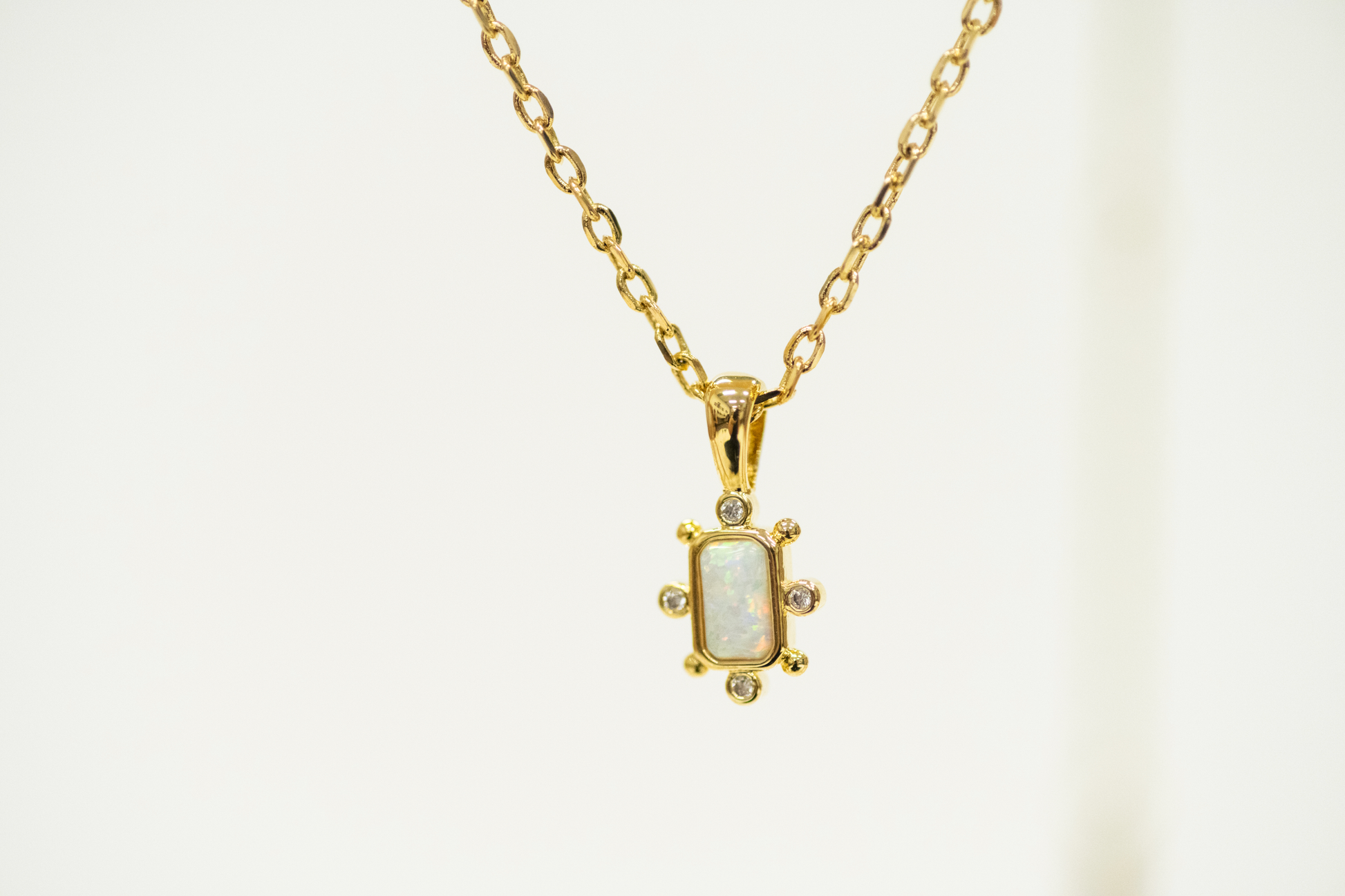 Opal Bar Shaped Pendant with Mini CZ studs on a gold Necklace