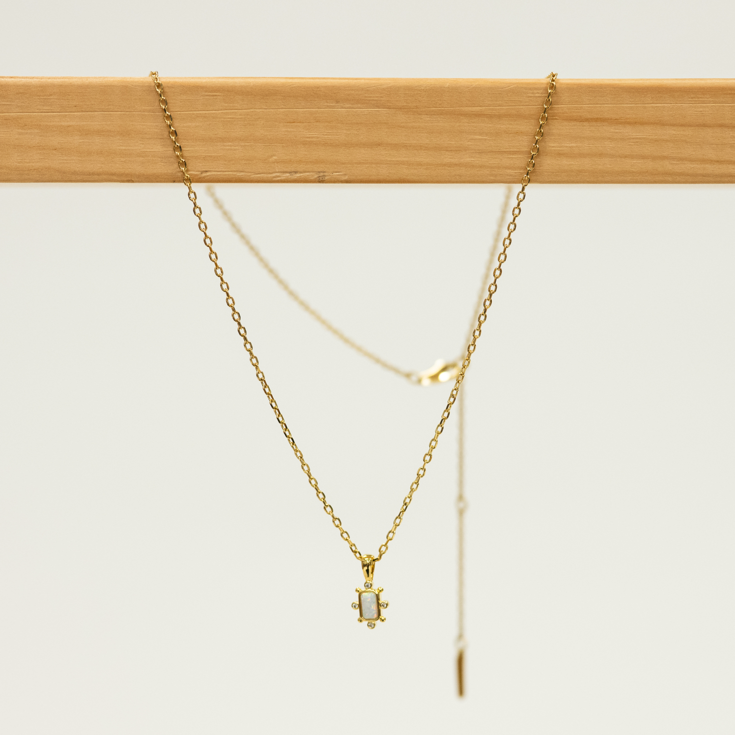 Opal Bar Shaped Pendant with Mini CZ studs on a gold Necklace