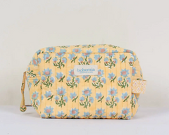 A yellow quilted storage bag with a floral pattern and the brand 'bohemian\' visible on the front.