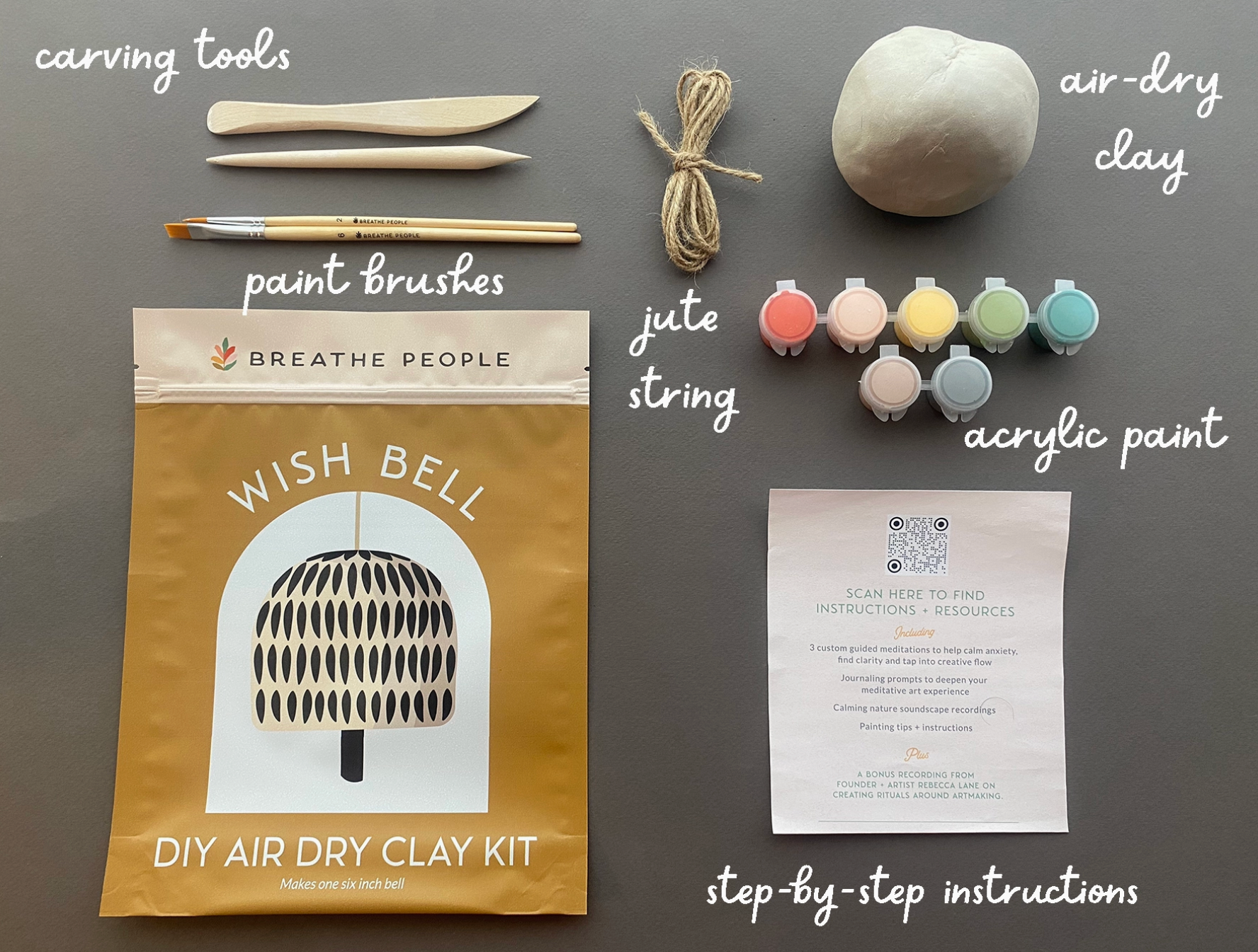 DIY air dry clay kit with tools and materials on a gray background