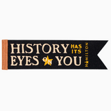 Black bookmark with gold text 'History has its Eyes on You' and a star, inspired by Hamilton, on a white background.