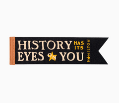 Black bookmark with gold text 'History has its Eyes on You' and a star, inspired by Hamilton, on a white background.