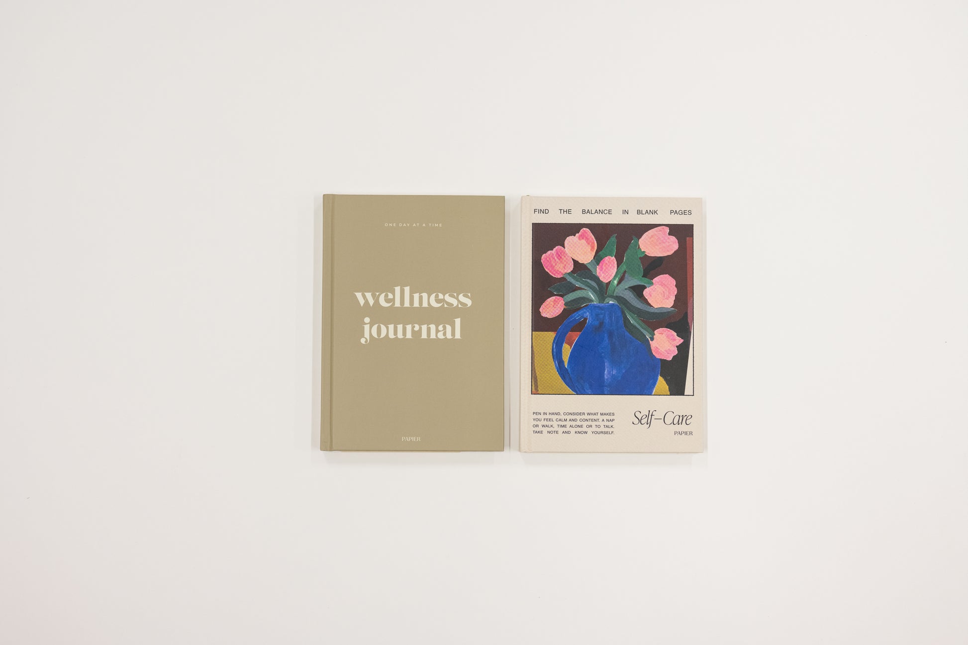 Wellness journal with a cover illustration of a blue pitcher and pink flowers on a white background