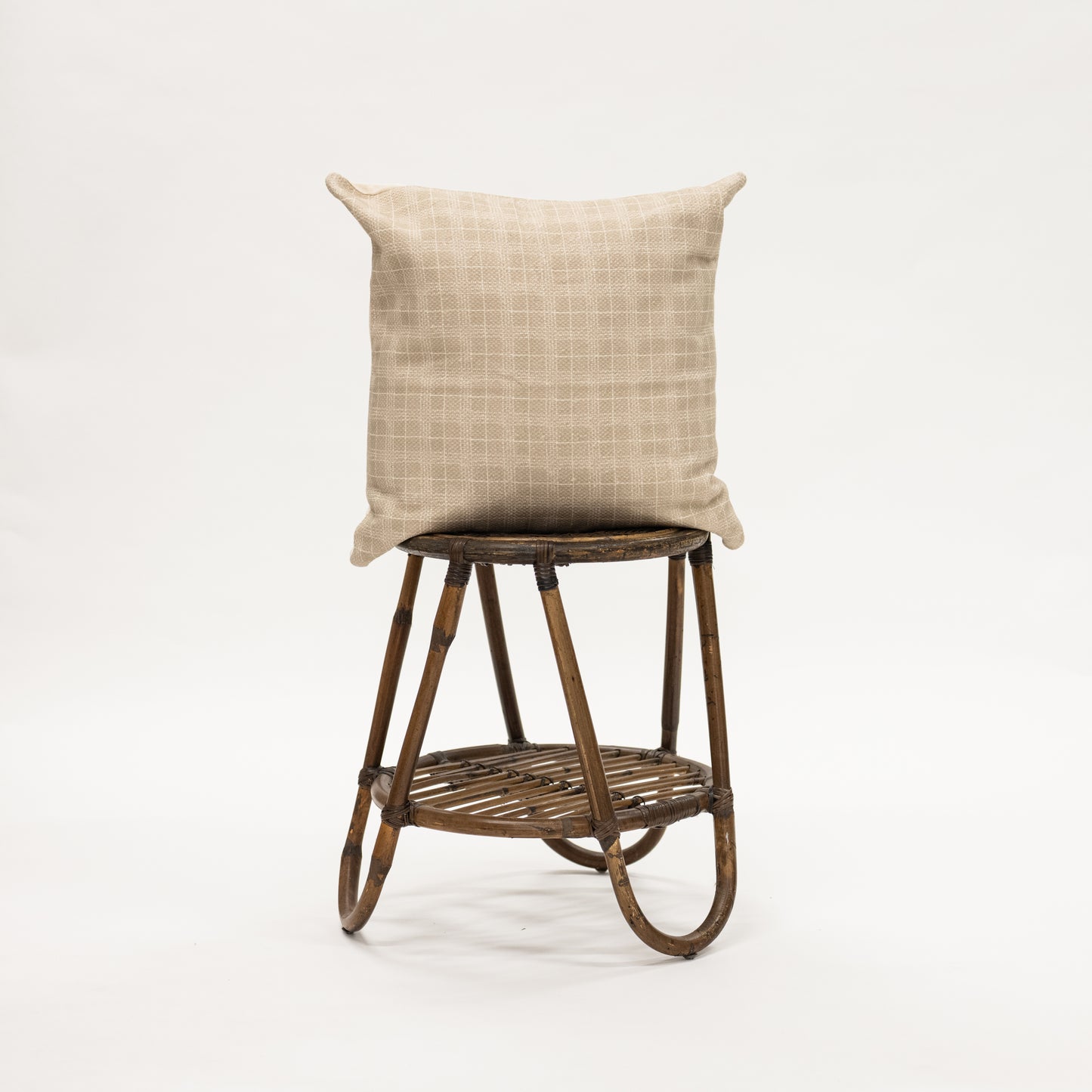 Taupe Window Pane Throw Pillow 22" size on wicker stool