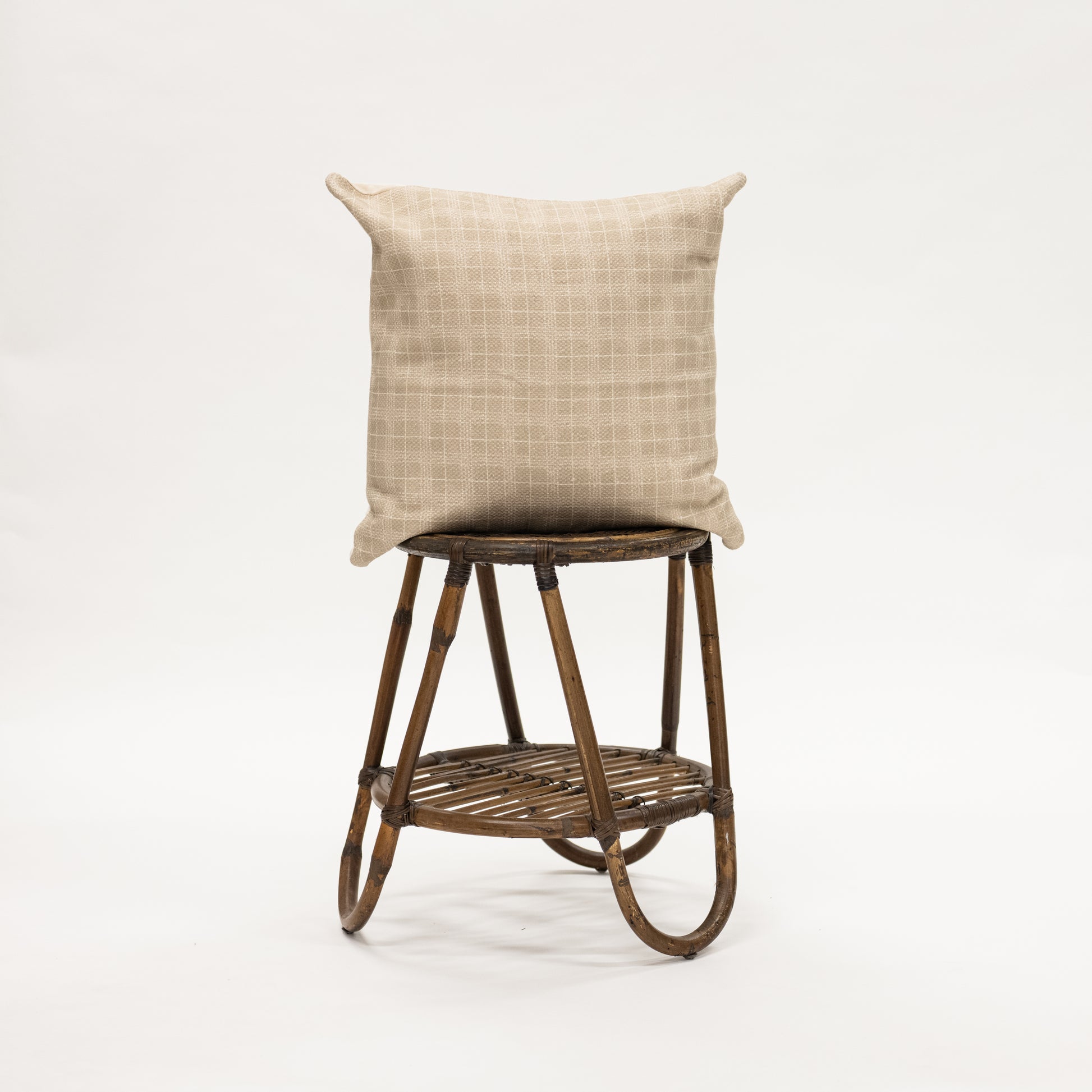 Taupe Window Pane Throw Pillow 22" size on wicker stool