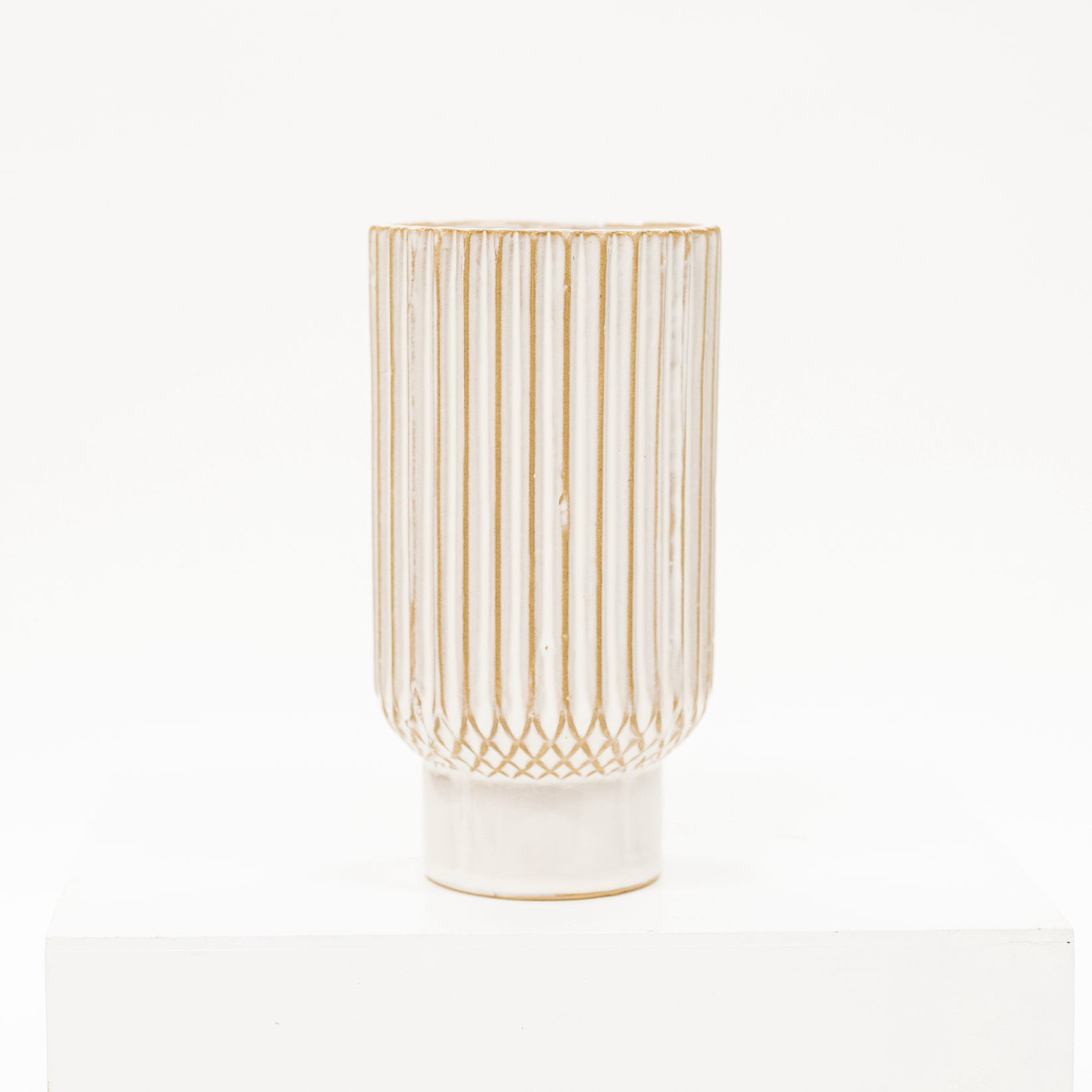 white ceramic vase with a ribbed style