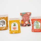 Four air dry clay kits with colorful packaging on a white background