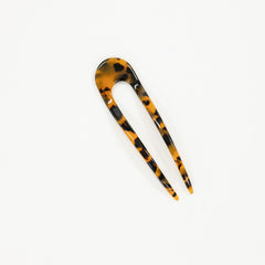 Tortoiseshell patterned hair clip on a white background
