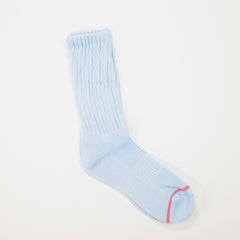 A light blue ribbed crew sock with a thin pink stripe near the toe, displayed on a clean white background.