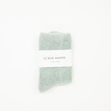 bay light blue cloud socks on a white surface, each with a label indicating the brand le bon shoppe