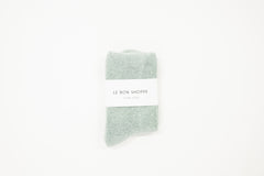 bay light blue cloud socks on a white surface, each with a label indicating the brand le bon shoppe