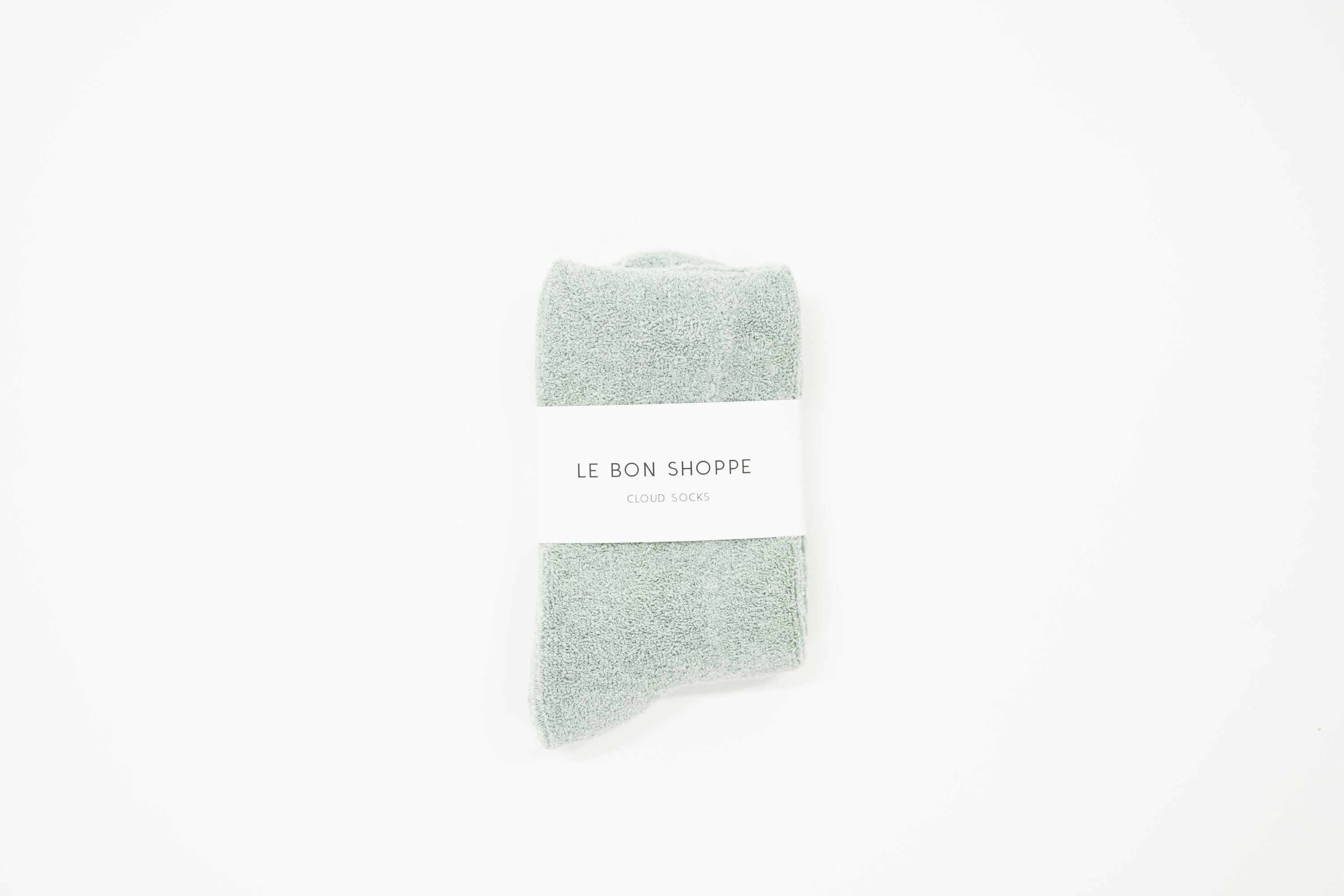 bay light blue cloud socks on a white surface, each with a label indicating the brand le bon shoppe