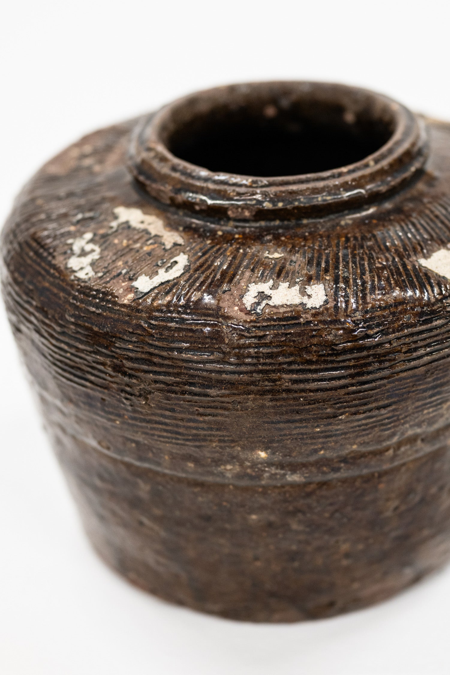 close up view of vintage bean pot with glossy finish