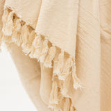 beige cotton throw blanket with tassels