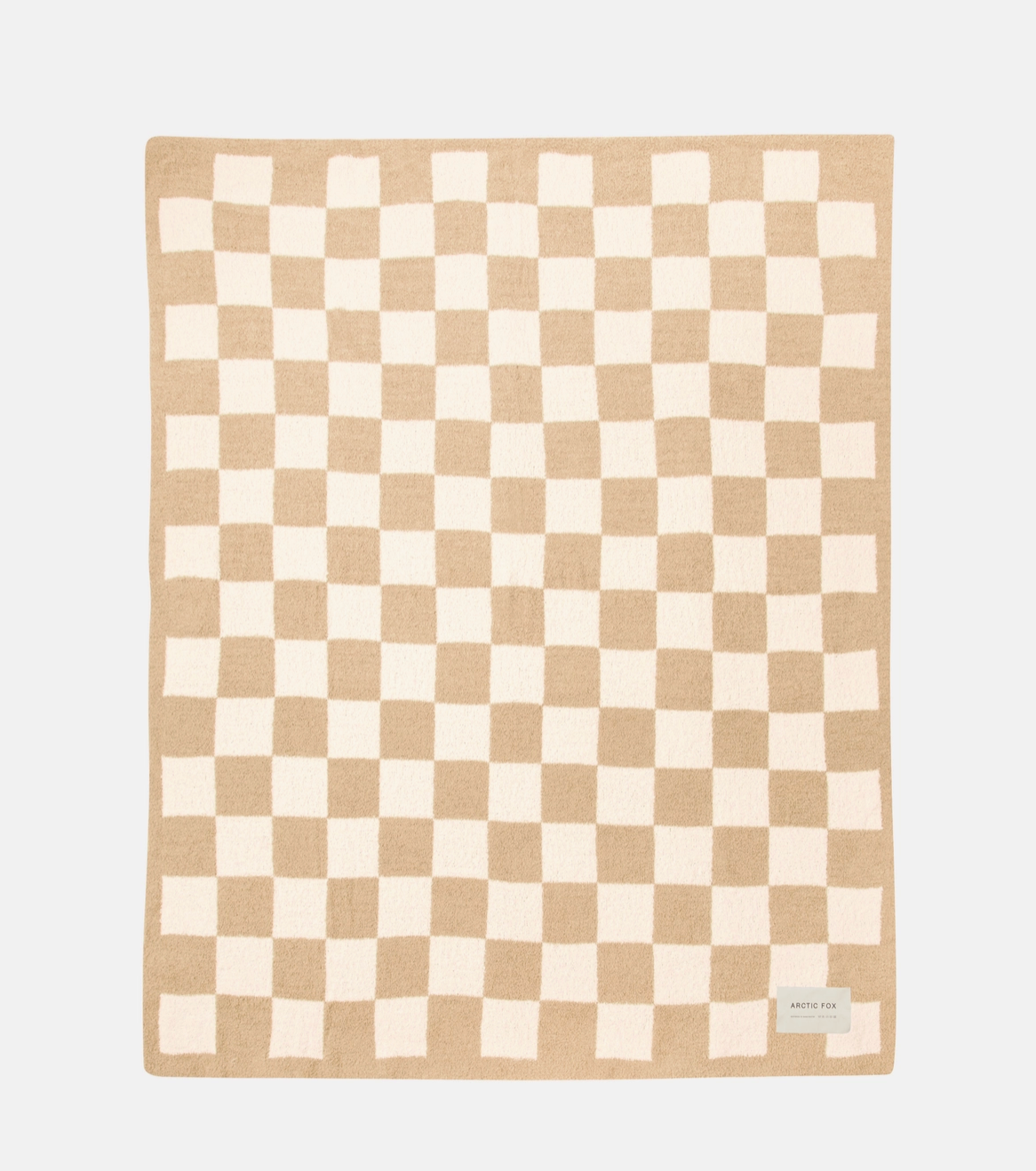 A square knit blanket featuring a beige and cream checkerboard pattern, displayed flat against a light gray background with a small brand label in the bottom right corner.