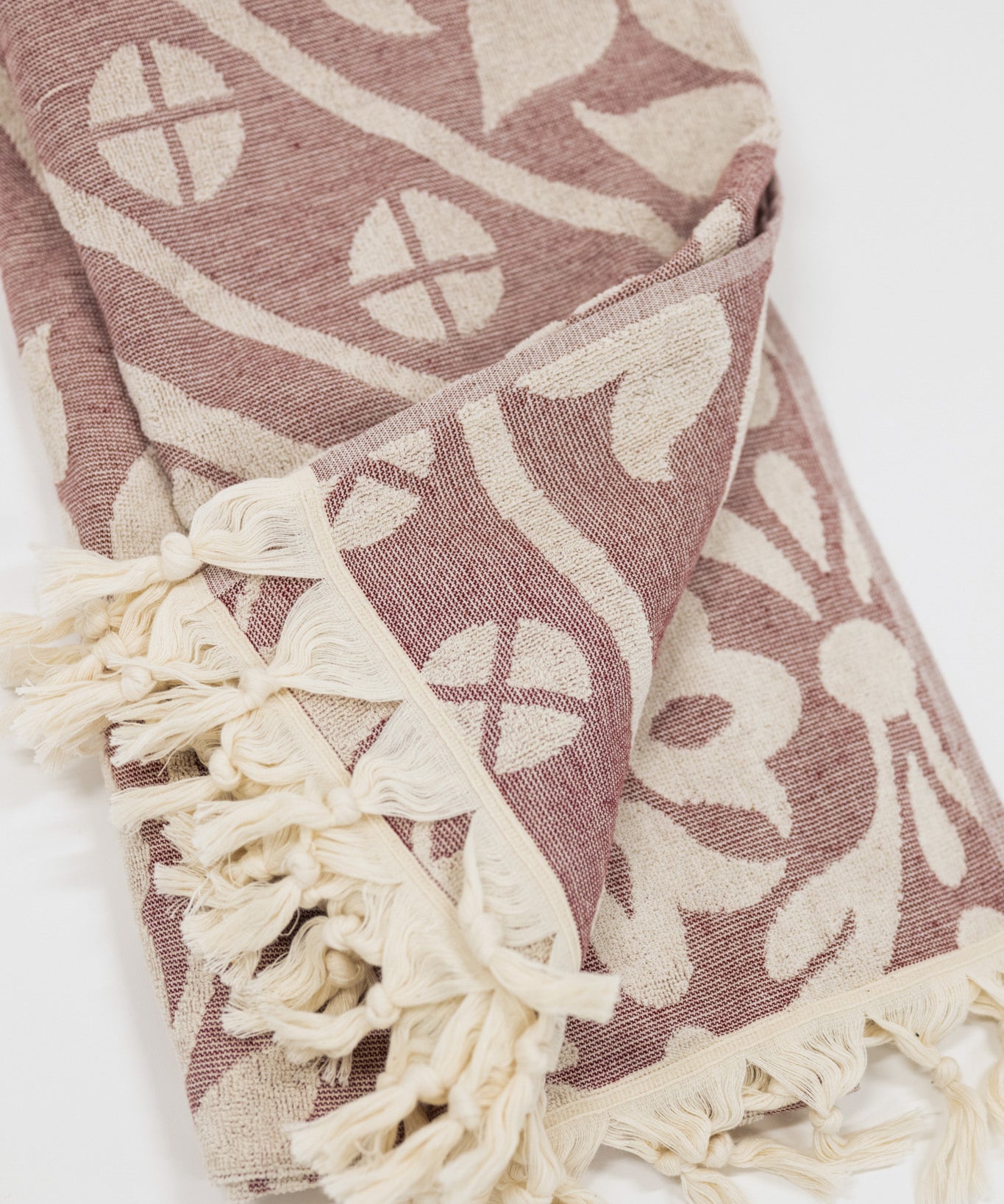 Patterned towel with tassels on a white background