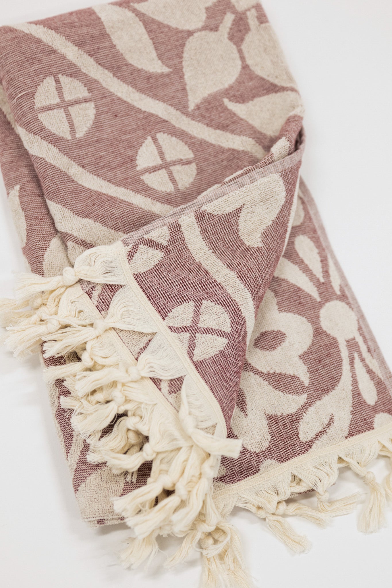 Patterned towel with tassels on a white background