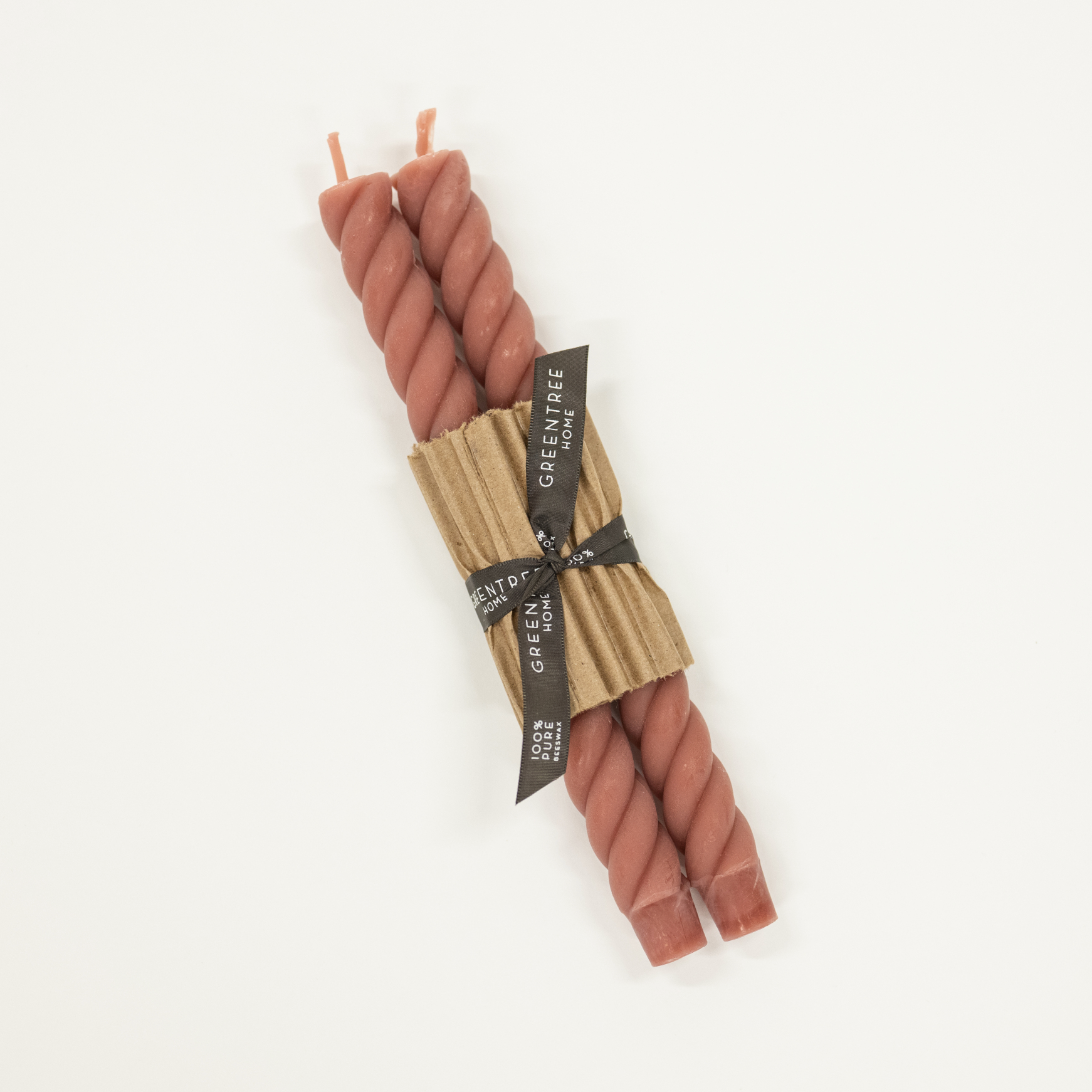pink braided candles tied with a paper wrap on a white background