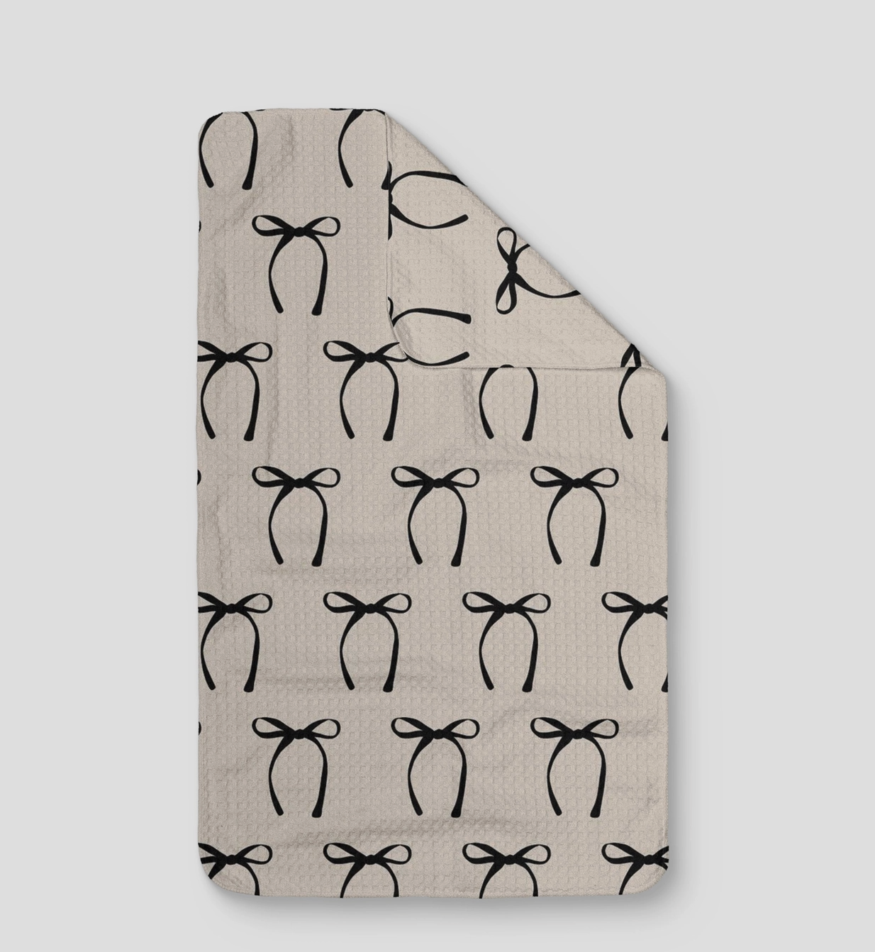 beige microfiber kitchen towel with black bow pattern