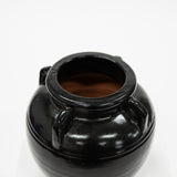 Black ceramic jar on a white background