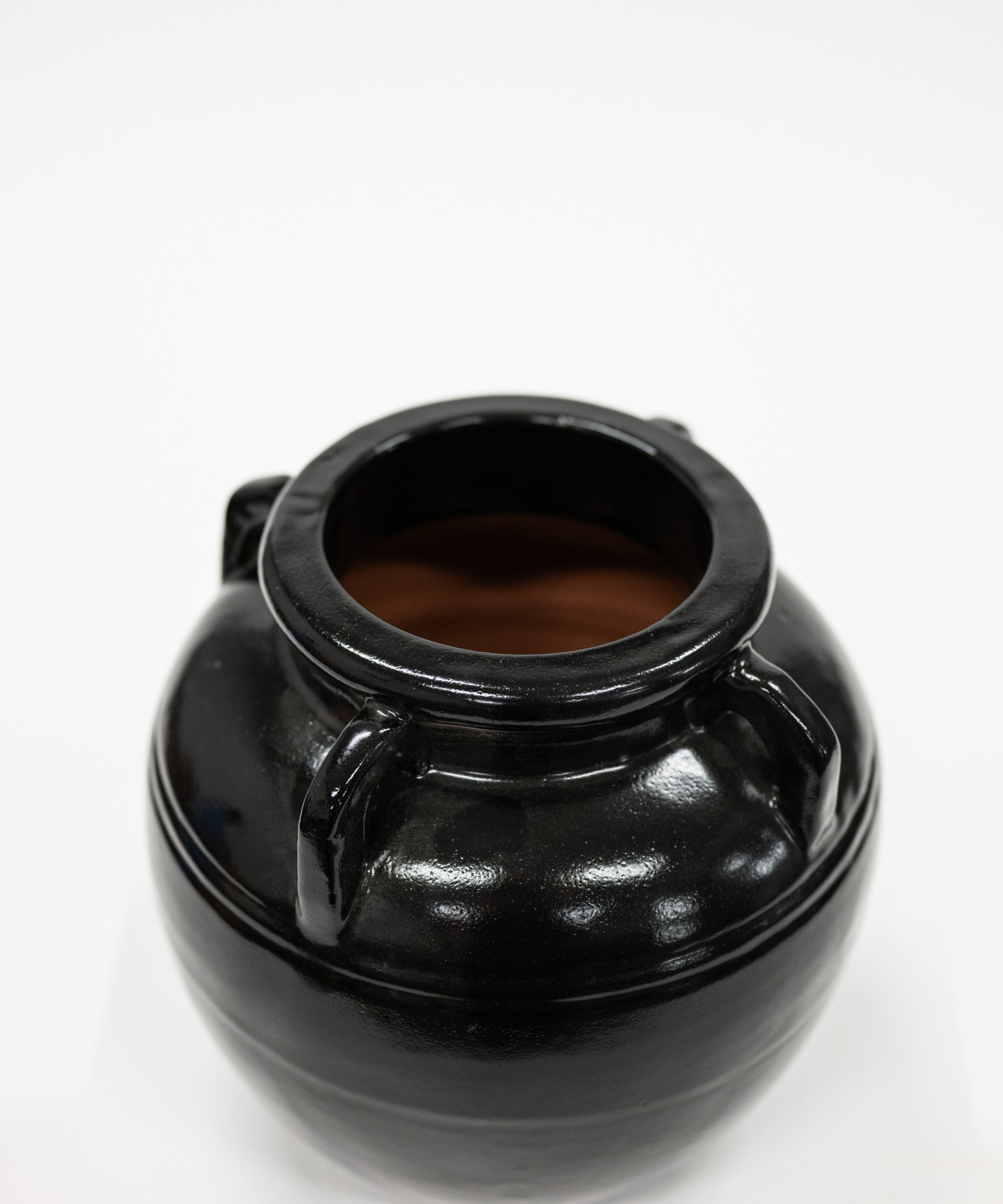 Black ceramic jar on a white background