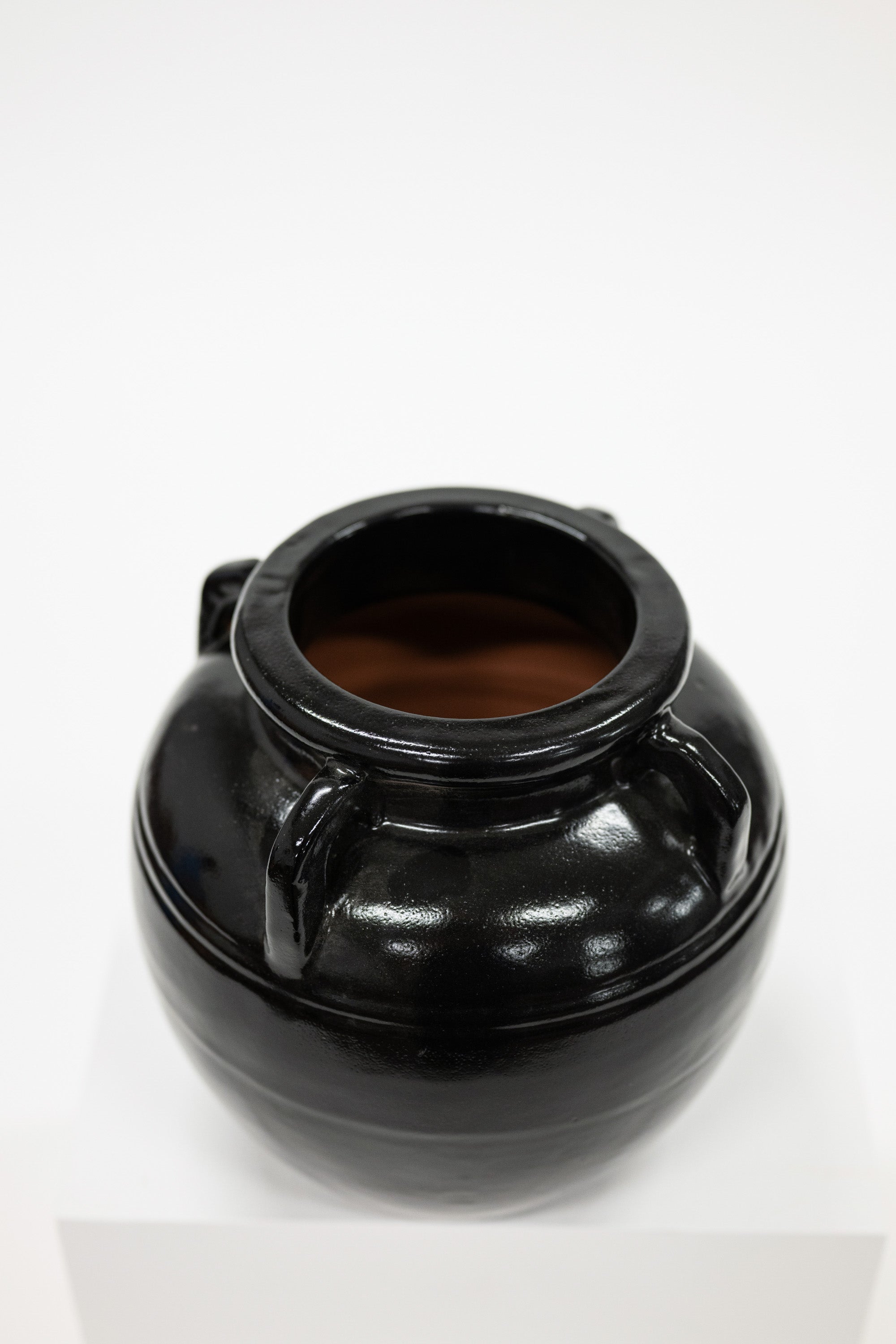 Black ceramic jar on a white background