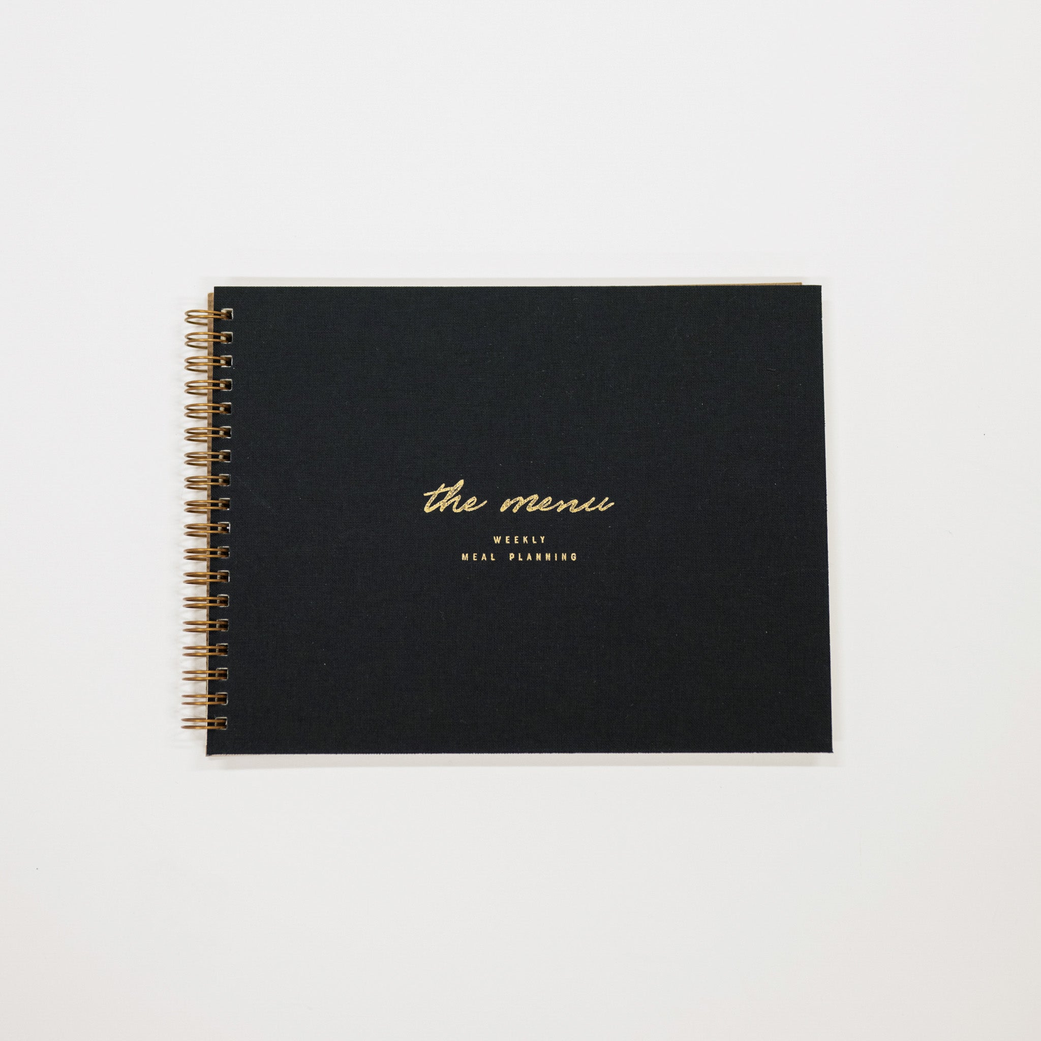 Black planner with gold text on a white background