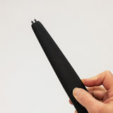 Black electronic device held in a hand against a light gray background