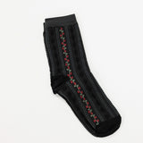 Black colored crew socks featuring scalloped stripes and a stripe of flowers.