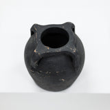 Black ceramic vase on a white background