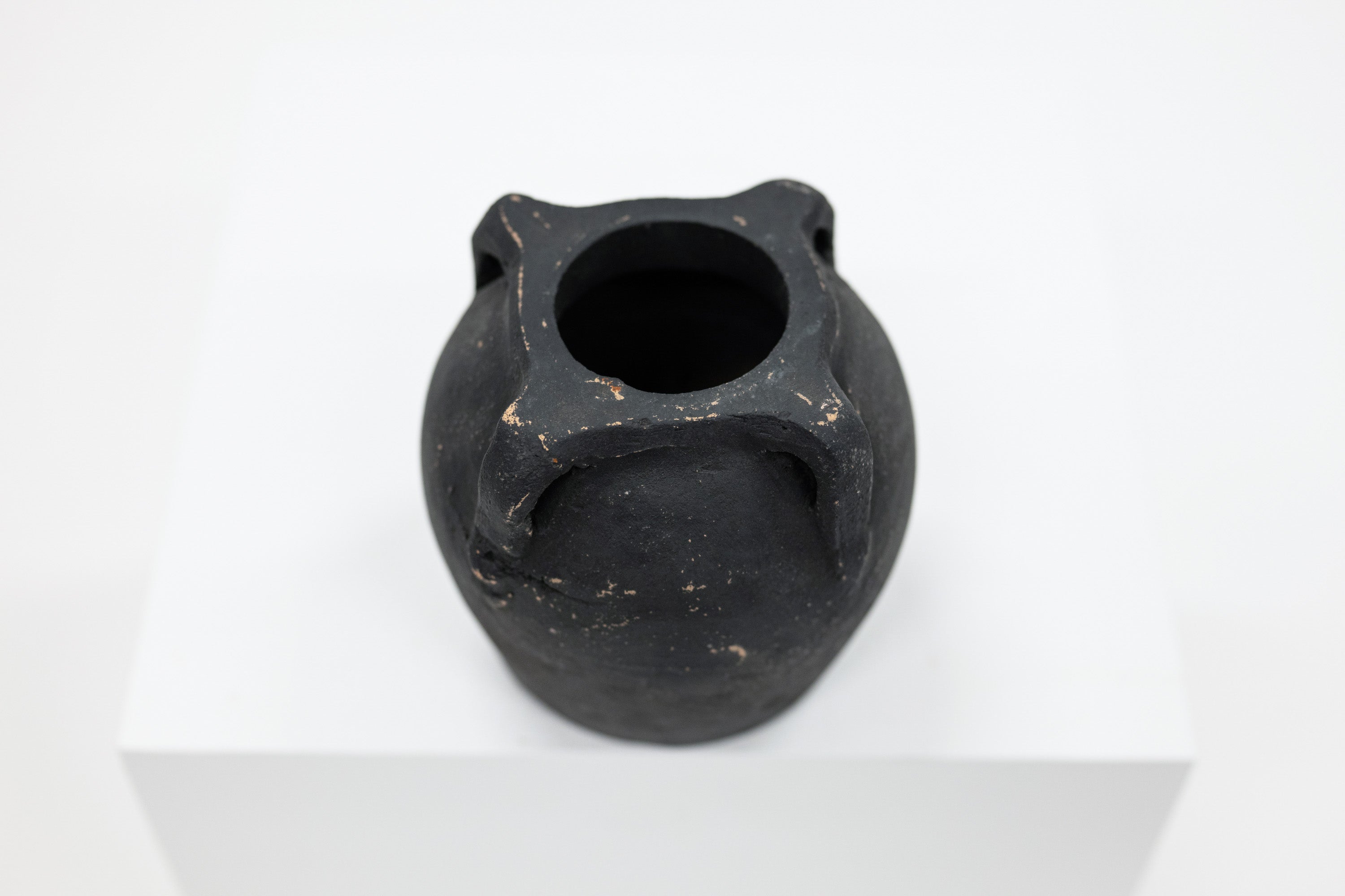 Black ceramic vase on a white background