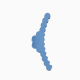 A light blue hair clip with scalloped edge and a small embossed brand logo, shown on a plain white background.
