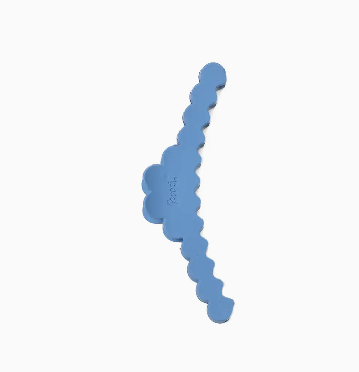 A light blue hair clip with scalloped edge and a small embossed brand logo, shown on a plain white background.