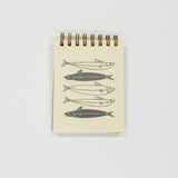 Notebook with fish illustrations on a white background