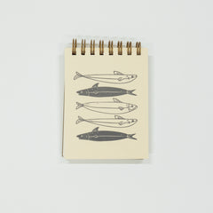 Notebook with fish illustrations on a white background