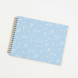 meal planner with a blue cover and white letter and white flowers.