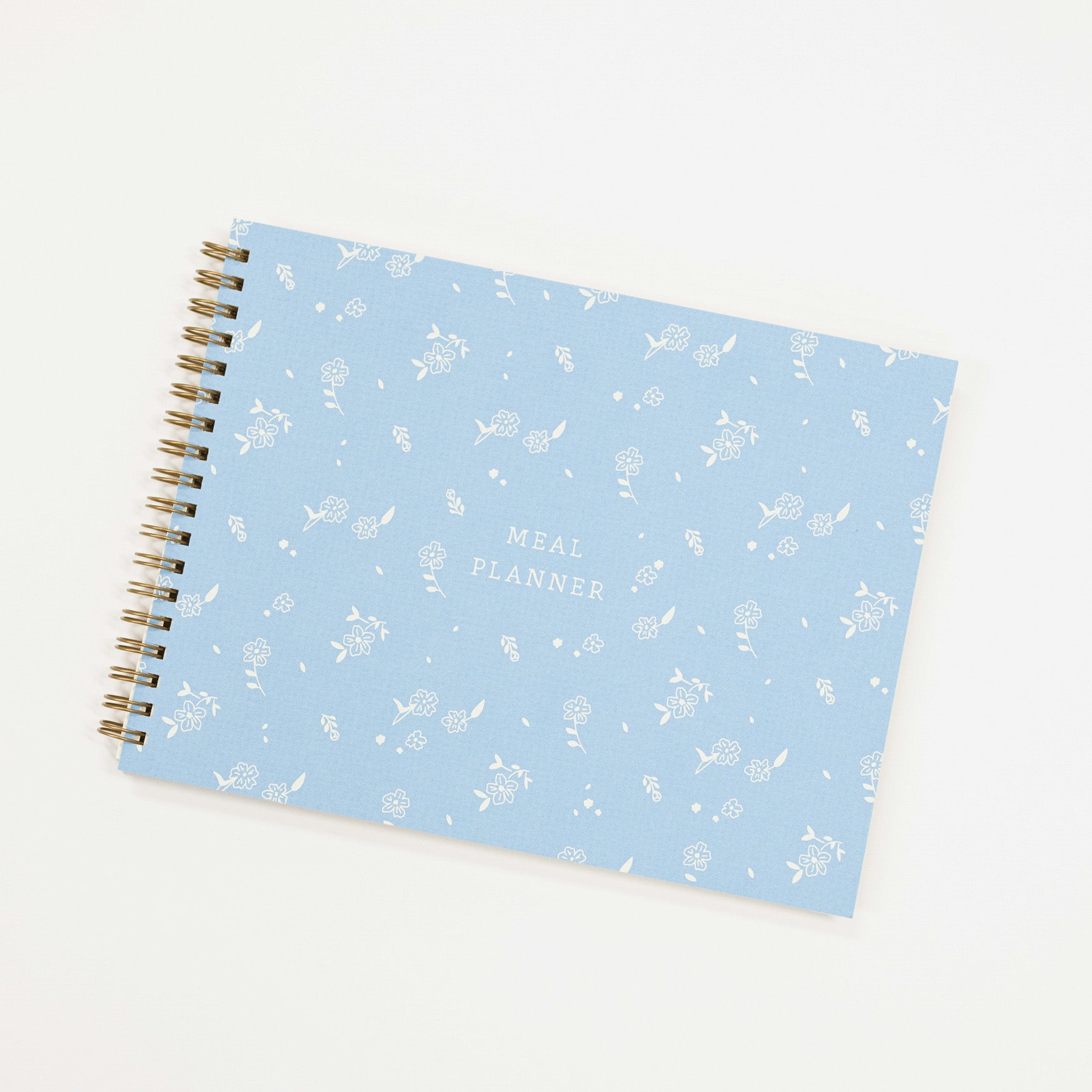 meal planner with a blue cover and white letter and white flowers.
