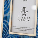 Framed picture with 'Styled Abode' branding and product details on a blue striped background.