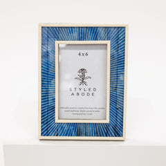 Framed picture with blue glass panel and 'Styled Abode' branding on a white background