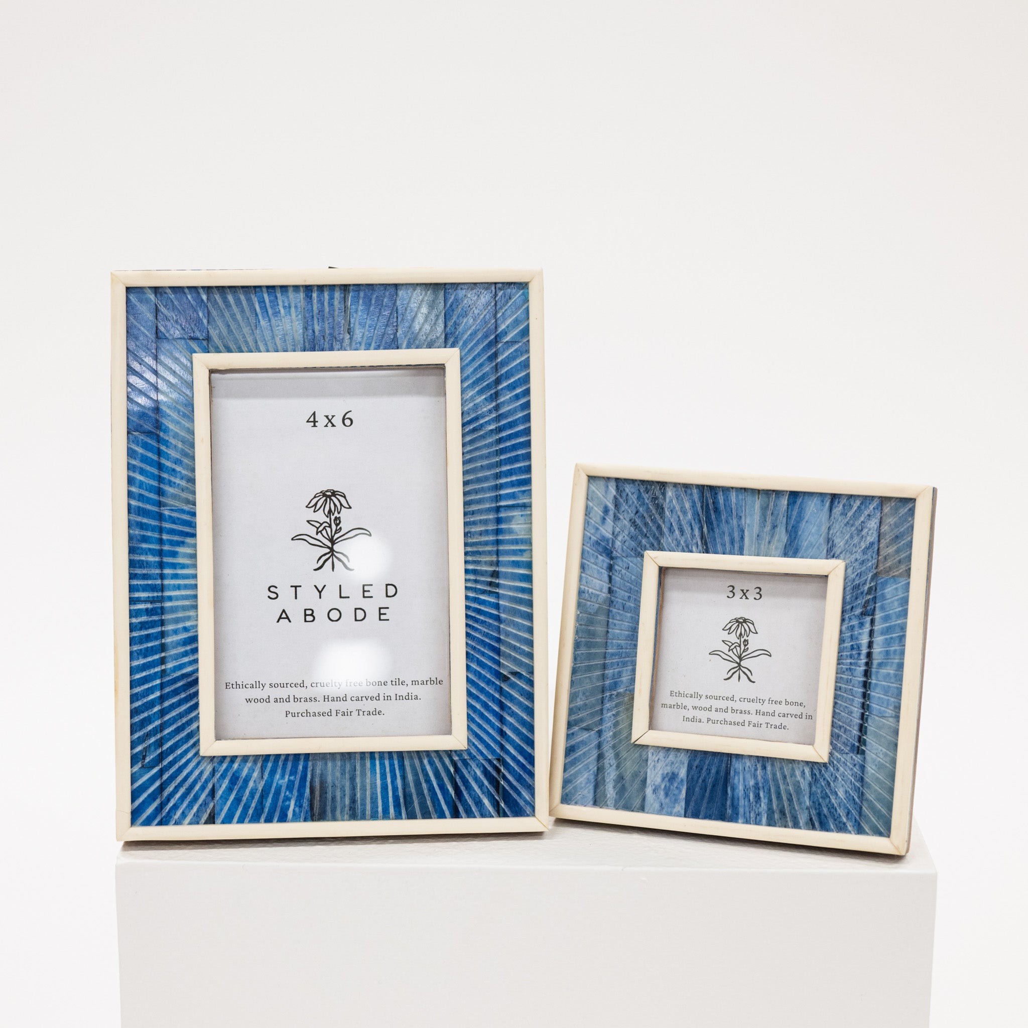 Two picture frames with blue abstract patterns on a white background